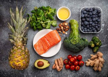 Anti inflammatory diet concept. Set of foods that help to reduce inflammation - plant based ingredients, fresh fruit, green vegetables. Healthy diet products, top view, stone background